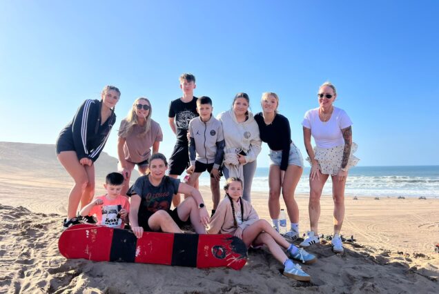 Sandboarding on dunes during quad excursion near Agadir