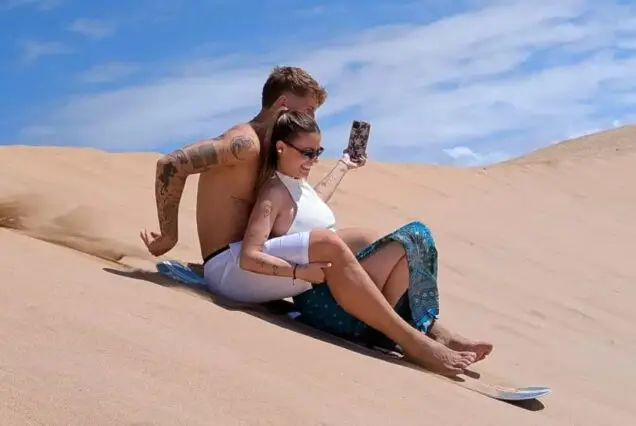 Sandboarding on dunes during quad excursion near Agadir
