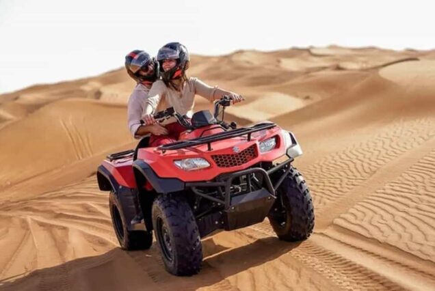 Sandboarding on dunes during quad excursion near Agadir